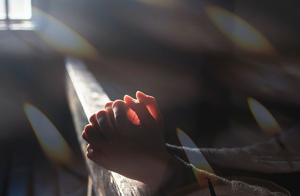 hands of a person praying