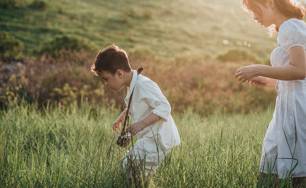 A child discovering something in the grass
