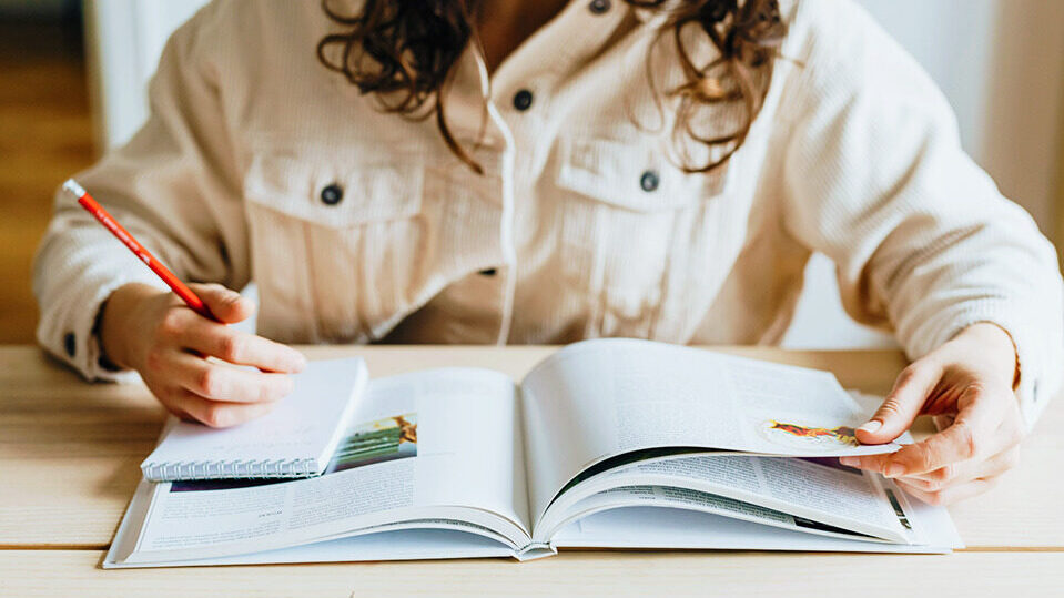 Woman-with-book-and-notepad